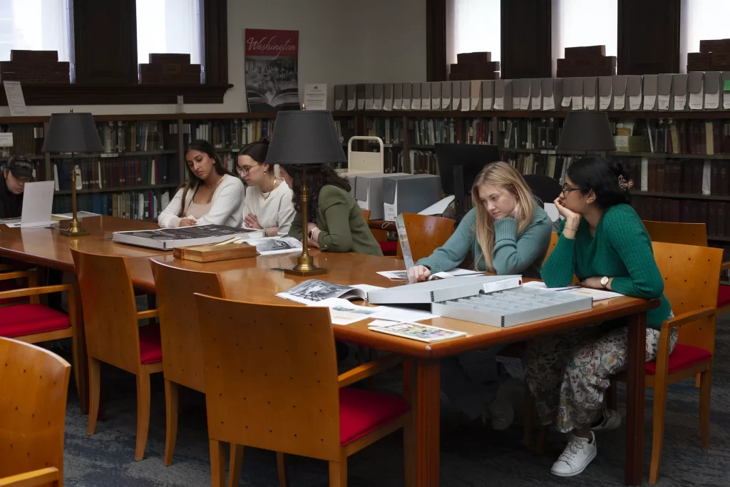 Graduate students view DC History Center collections inside the Kiplinger Research Library.