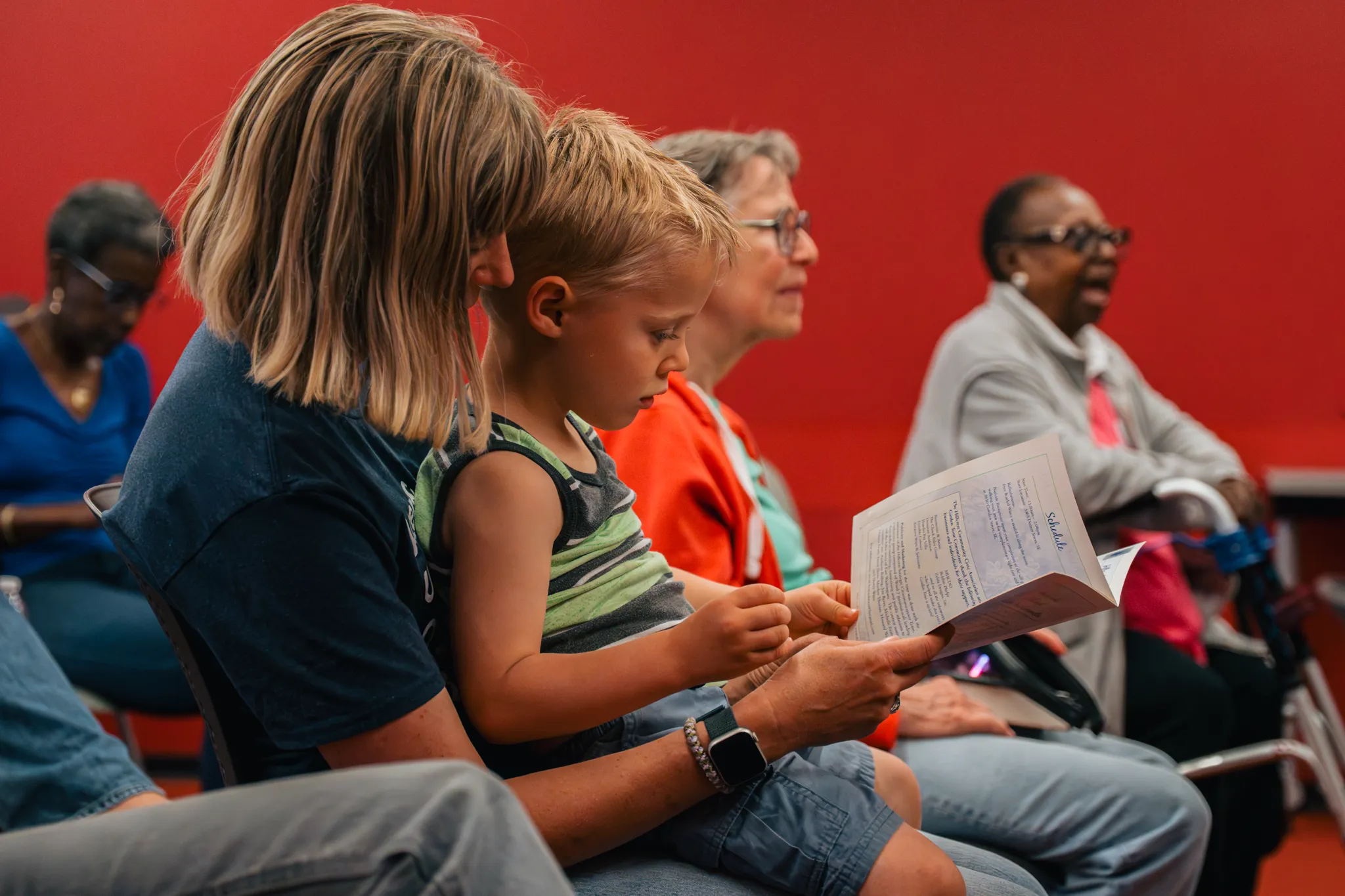 woman reading to son during a program, promotion for beginner genealogy workshop