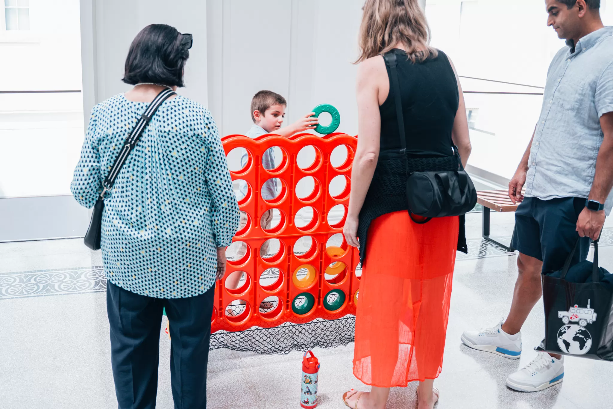 Family plays with a giant Connect 4 set.