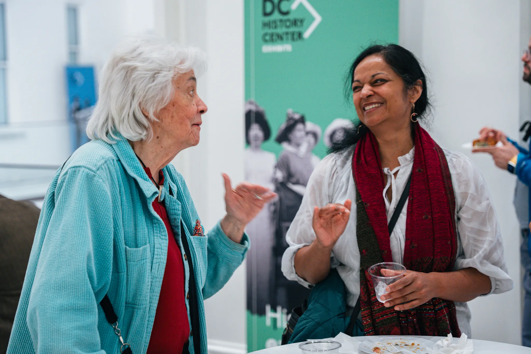 two women talk and laugh at the DC History Center
