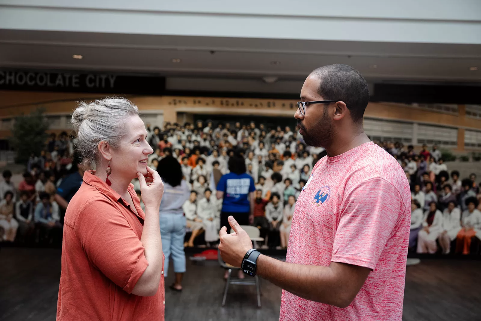 Deputy Director Anne McDonough speaks with a teacher inside the "Class Action" exhibit.