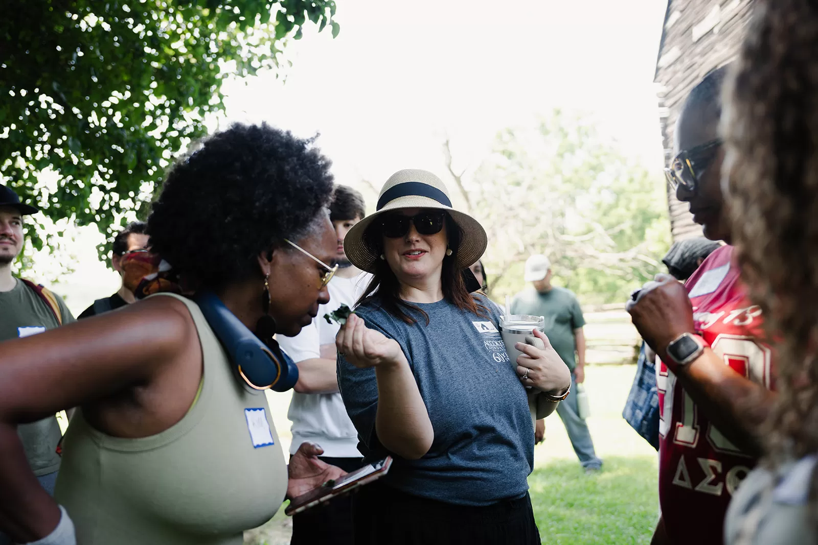 Accokeek Foundation staff have guess the plant based on the smell of the leaf she is holding (it was sassafras, which was used to make root beer).