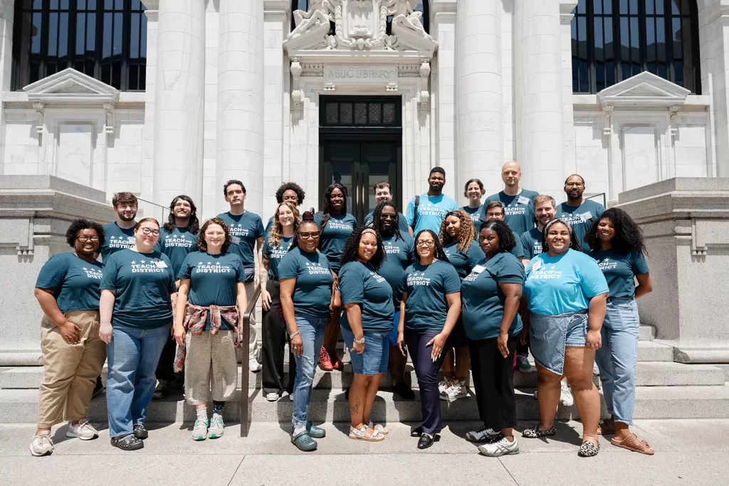 The 2025 Teach the District cohort poses for a group photo outside the Carnegie Library.