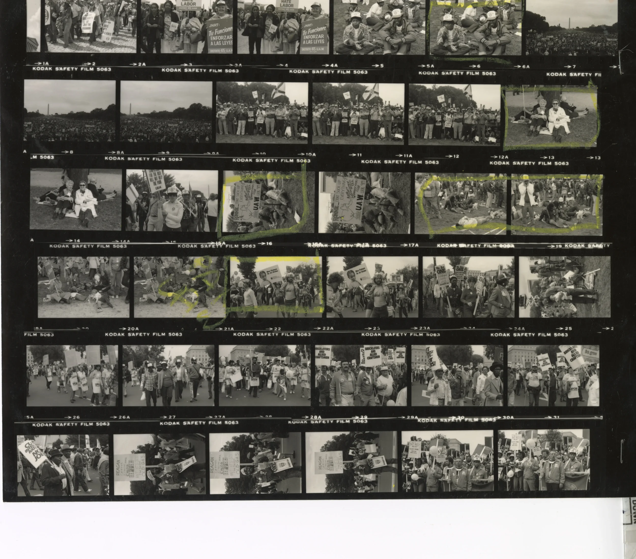 A contact sheet of black and white photographs with images of a march with people holding protest signs.